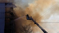 Petugas pemadam kebakaran berupaya memadamkan api di bursa saham bersejarah Kopenhagen. REUTERS/Ali Withers  