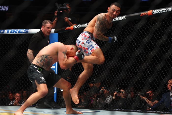 Apr 13, 2024; Las Vegas, Nevada, USA; Max Holloway (blue gloves) fights Justin Gaethje (red gloves) during UFC 300 at T-Mobile Arena. Mandatory Credit: Mark J. Rebilas-USA TODAY Sports