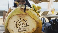 Saat liburan di Bali, Zanzabella juga menikmati waktu santainya di beach club. Ia pun menikmati kelapa muda yang segar. Foto: Instagram @zanzabellaa