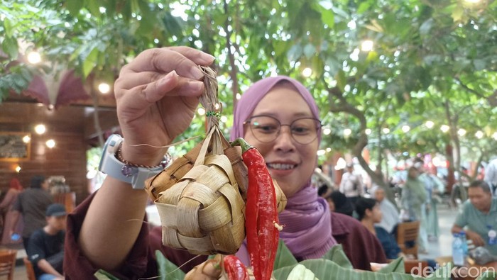 Pengunjung memamrkan ketupat coklat doi Kampung Coklat Blitar
