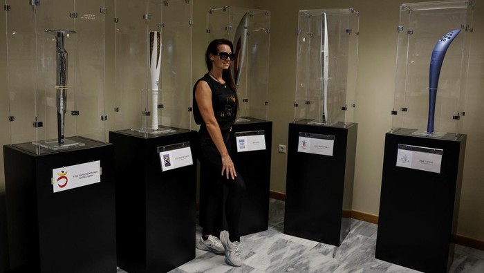 A visitor looks at the exhibits from the collection of Stratos Klimou, during a temporary exhibition of historic Olympic torches in Ancient Olympia, Greece, April 16, 2024.  REUTERS/Louisa Gouliamaki