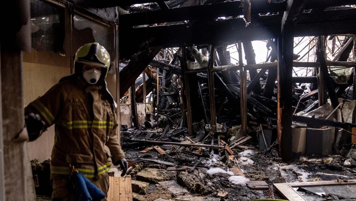Fire crew members work inside the Old Stock Exchange building, the day following the fire, in Copenhagen, Denmark, April 17, 2024.  Ritzau Scanpix/Ida Marie Odgaard via REUTERS    ATTENTION EDITORS - THIS IMAGE WAS PROVIDED BY A THIRD PARTY. DENMARK OUT. NO COMMERCIAL OR EDITORIAL SALES IN DENMARK.