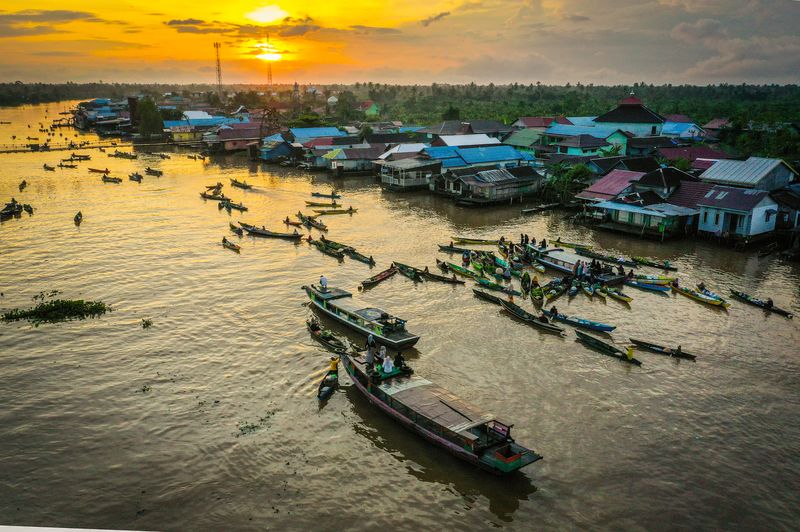 Foto udara sejumlah pedagang menjajakan dagangannya di atas perahu (jukung) di Pasar Terapung Lok Baintan, Kabupaten Banjar, Kalimantan Selatan, Kamis (18/4/2023). Pasar yang berada di aliran Sungai Martapura tersebut merupakan pasar tradisional yang menjual beragam dagangan hasil produksi pertanian dan perkebunan masyarakat setempat dari atas Jukung. ANTARA FOTO/Bayu Pratama S/aww.
