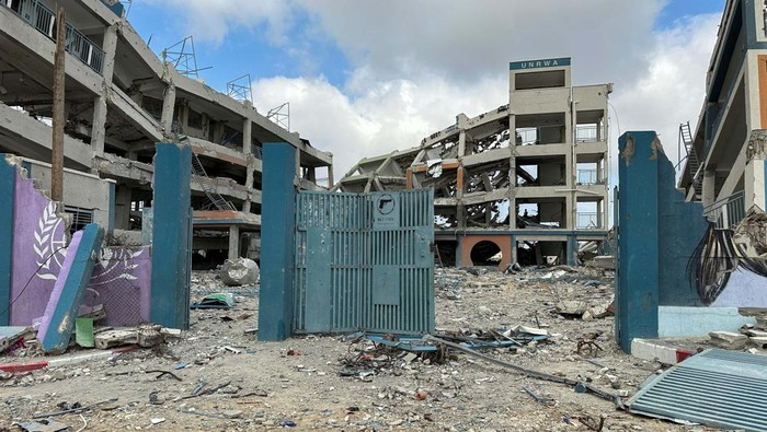 Palestinian school children Abed Al-Qara and Muhammad Al-Fajem inspect their school which was destroyed during Israels military offensive, amid the ongoing conflict between Israel and Hamas, in Khan Younis in the southern Gaza Strip, April 14, 2024. REUTERS/Doaa Rouqa