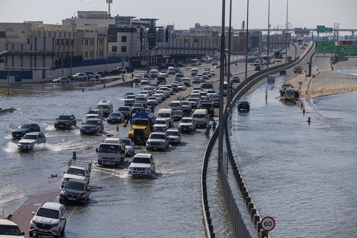 Vehicles drive through standing floodwater caused by heavy rain on Sheikh Zayed Road highway in Dubai, United Arab Emirates, Thursday, April 18, 2024. The United Arab Emirates attempted to dry out Thursday from the heaviest rain the desert nation has ever recorded, a deluge that flooded out Dubai International Airport and disrupted flights through the worlds busiest airfield for international travel. (AP Photo/Christopher Pike)