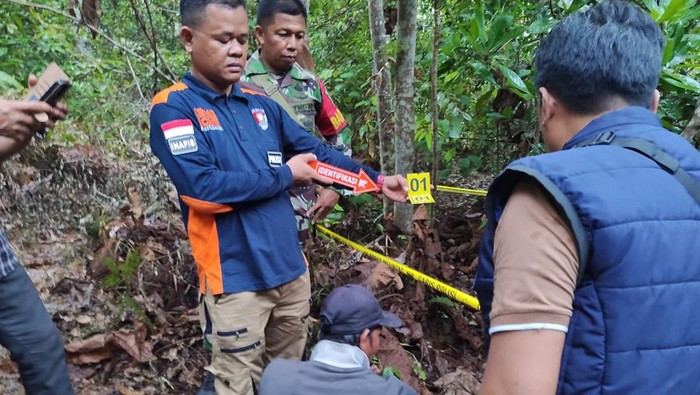 Polisi melakukan olah tkp pembunuhan pria dan wanita ditemukan di kebun karet