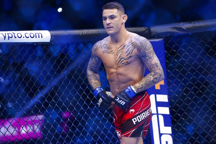 Dustin Poirier enters the octagon before a lightweight mixed martial arts title bout against Charles Oliveira, not pictured, at UFC 269, Saturday, Dec. 11, 2021, in Las Vegas. (AP Photo/Chase Stevens)