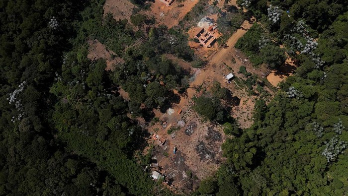 A drone view shows the city and an area under permanent protection that was illegally deforested, in Aruja, on the outskirts of Sao Paulo, Brazil April 21, 2024. REUTERS/Amanda Perobelli