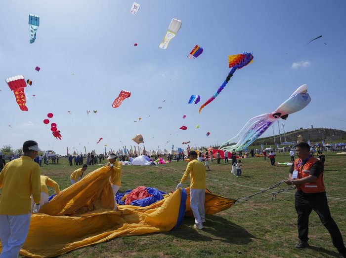 Kites lie on the ground during the 41st International Kite Festival in Weifang, Shandong Province of China, Saturday, April 20, 2024. (AP Photo/Tatan Syuflana)