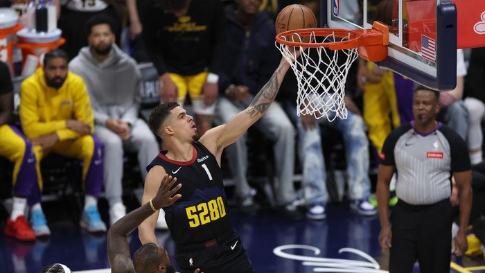 DENVER, COLORADO - APRIL 22: Michael Porter Jr. #1 of the Denver Nuggets lays in a basket against LeBron James #23 of the Los Angeles Lakers in the first quarter during game two of the Western Conference First Round Playoffs at Ball Arena on April 22, 2024 in Denver, Colorado. NOTE TO USER: User expressly acknowledges and agrees that, by downloading and or using this photograph, User is consenting to the terms and conditions of the Getty Images License Agreement. (Photo by Matthew Stockman/Getty Images)