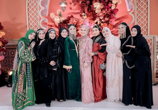 Gaun yang dikenakan Irish itu tampak elegan dengan motif bunga berpayet di lapisan tulle dan hijabnya. Berpose bersama para tamu wanita yang hadir, Irish tampak memamerkan senyum sumringahnya. Foto: Instagram/@_irishbella_