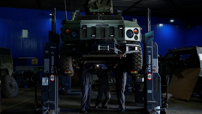 Employees repair a Novator armoured personnel carrier at a production facility of the 'Ukrainian Armor' Design and Manufacturing Company, amid Russia's attack on Ukraine, in an undisclosed location in Ukraine April 9, 2024. REUTERS/Valentyn Ogirenko