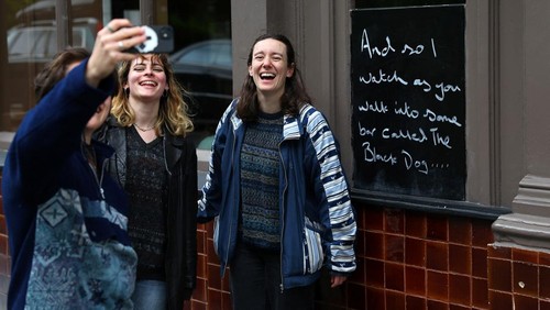 Customers sit outside The Black Dog pub, believed by its owners to have been referenced in lyrics in the song The Black Dog by Taylor Swift, in London, Britain, April 22, 2024. REUTERS/Toby Melville