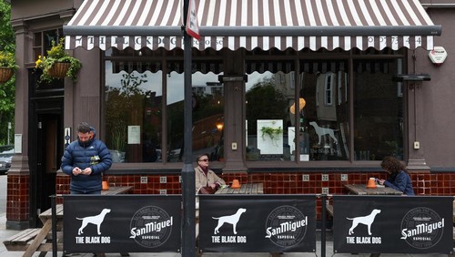 Customers sit outside The Black Dog pub, believed by its owners to have been referenced in lyrics in the song The Black Dog by Taylor Swift, in London, Britain, April 22, 2024. REUTERS/Toby Melville