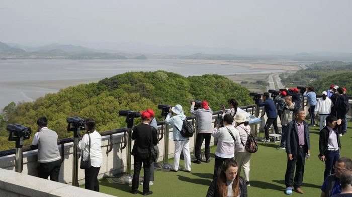 Visitors watch North Korean side from the Unification Observation Post in Paju, South Korea, near the border with North Korea, Tuesday, April 23, 2024. North Korean leader Kim Jong Un supervised salvo launches of the country's 
