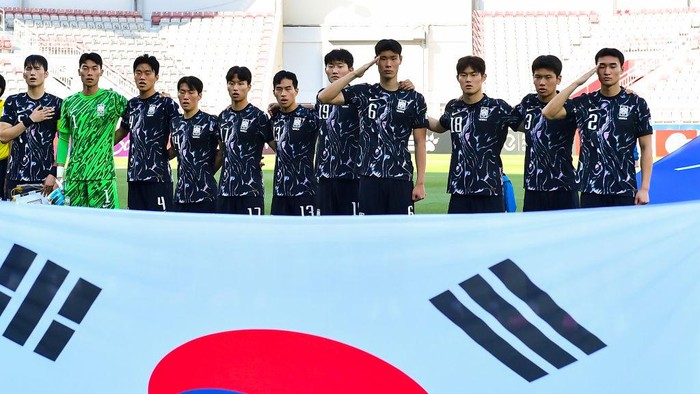 The South Korean players are standing for the national anthem ahead of the AFC U23 Asian Cup Qatar 2024 Group B match between China and South Korea at Abdullah Bin Khalifa Stadium in Doha, Qatar, on April 19, 2024. (Photo by Noushad Thekkayil/NurPhoto via Getty Images)
