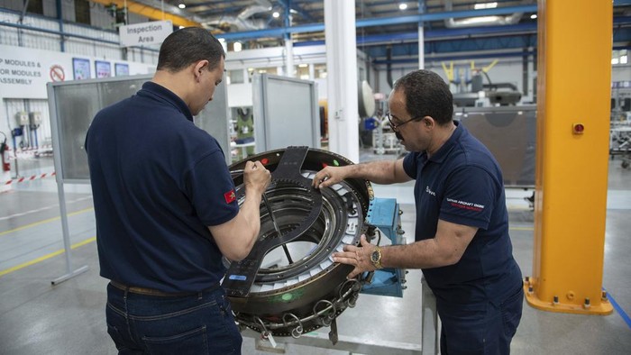 Engineers and workers stand inside Safran Aircraft Engines repair plant outside of Casablanca, Morocco, Thursday, April 18, 2024. Moroccan officials are aiming to turn the country into an aerospace hub, luring investors and manufacturers who have aimed to spread out their supply chains and find willing workers since the COVID-19 pandemic. (AP Photo)