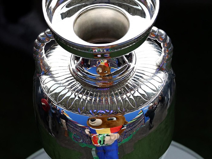 Soccer Football - Euro 2024 - Trophy Display at Olympiastadion - Olympiastadion, Berlin, Germany - April 24, 2024 Euro 2024 mascot Albart poses with the European Championship trophy REUTERS/Liesa Johannssen