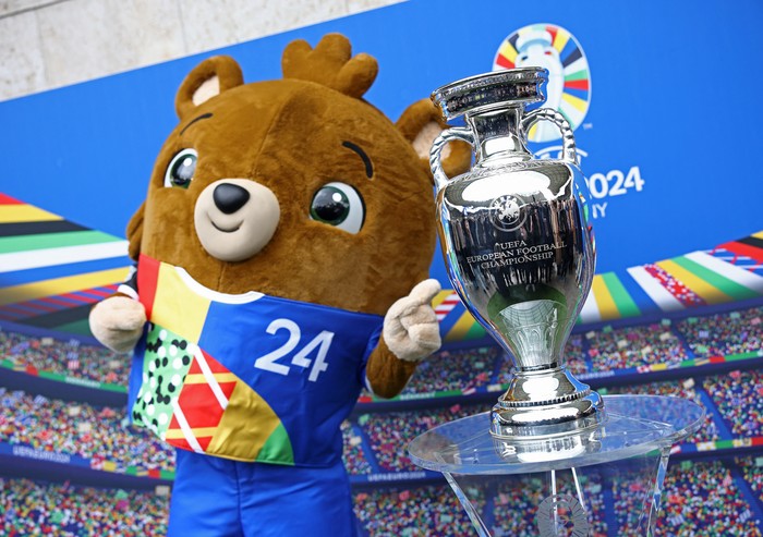 Soccer Football - Euro 2024 - Trophy Display at Olympiastadion - Olympiastadion, Berlin, Germany - April 24, 2024 Euro 2024 mascot Albart poses with the European Championship trophy REUTERS/Liesa Johannssen