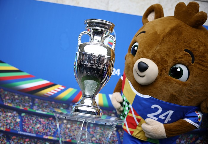Soccer Football - Euro 2024 - Trophy Display at Olympiastadion - Olympiastadion, Berlin, Germany - April 24, 2024 Euro 2024 mascot Albart poses with the European Championship trophy REUTERS/Liesa Johannssen