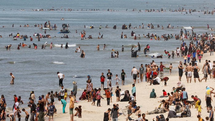Palestinians enjoy the beach on a hot day, amid the ongoing conflict between Israel and Hamas, in Rafah, in the southern Gaza Strip, April 24, 2024. REUTERS/Mohammed Salem      TPX IMAGES OF THE DAY