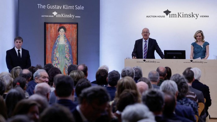 Auctionator Michael Kovacek, co-managing Director of Kinsky Auction House, oversees the bidding during the auction for Austrian artist Gustav Klimt's portrait 