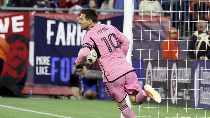 Inter Miami forward Lionel Messi (10) retrieves the ball from the net after scoring in the first half of an MLS soccer match against the New England Revolution, Saturday, April 27, 2024, in Foxborough, Mass. (AP Photo/Mark Stockwell)