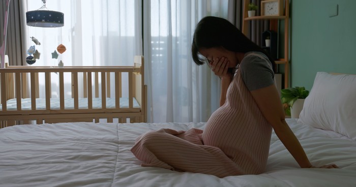 silhouette asian pregnant woman feel depressed about being new mother