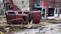 Kaca mobil juga pecah akibat tertimpa puing bangunan. AP Photo/Ken Miller.