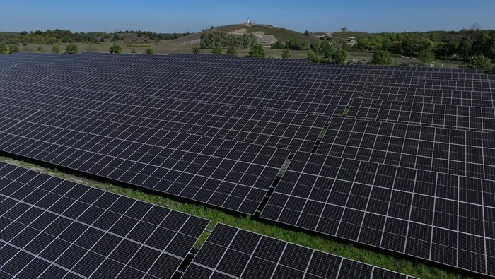 NOCHTEN, GERMANY - APRIL 30: In this aerial view the Boxberg coal-fired power plant stands behind the newly inaugurated PV-Park Boxberg solar energy park on April 30, 2024 in Nochten, Germany. LEAG, the energy company that owns both, is building what it claims will be Germany's biggest concentration of green energy production, with solar energy parks and wind farms that will have a capacity of seven gigawatts by 2030 under the so-called GigawattFactory project. The Boxberg solar park stands on recultivated land of a former open-pit coal mine. The region of southern Brandenburg and northern Saxony has long been heavily dependent on coal. Germany is seeking to shutter its coal-fired energy production by 2038.  (Photo by Sean Gallup/Getty Images)