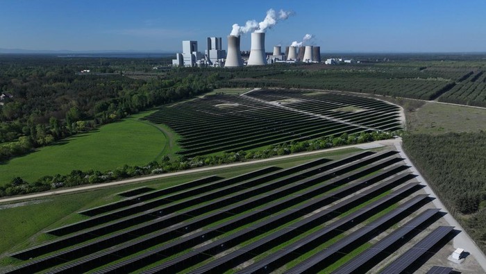 2150793539 NOCHTEN, GERMANY - APRIL 30: In this aerial view the Boxberg coal-fired power plant stands behind the newly inaugurated PV-Park Boxberg solar energy park on April 30, 2024 in Nochten, Germany. LEAG, the energy company that owns both, is building what it claims will be Germany's biggest concentration of green energy production, with solar energy parks and wind farms that will have a capacity of seven gigawatts by 2030 under the so-called GigawattFactory project. The Boxberg solar park stands on recultivated land of a former open-pit coal mine. The region of southern Brandenburg and northern Saxony has long been heavily dependent on coal. Germany is seeking to shutter its coal-fired energy production by 2038. (Photo by Sean Gallup/Getty Images)