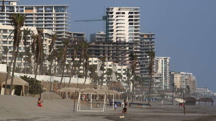 Tourists are seen at a beach in Punta Diamante, six months after Hurricane Otis hit Acapulco, Mexico, April 25, 2024. REUTERS/Javier Verdin