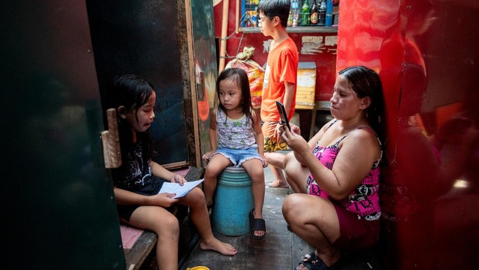 A student answers his learning module following the suspension of in-person classes, inside his house in Manila, Philippines, April 26, 2024. REUTERS/Lisa Marie David