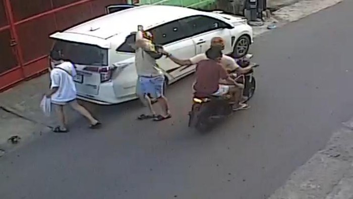 Tangkapan layar video seorang warga dijambret dua pria saat baru saja keluar dari mobil di Jalan Pukat VI, Kota Medan, beredar di media sosial. (Istimewa)