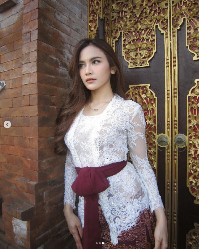 Pada 13 April 2024, Mahalini memamerkan fotonya mengenakan kebaya putih brokat rancangan Asky Febrianti. Sesuai ciri khas kebaya Bali, penampilannya dilengkapi selendang warna merah marun yang dililitkan ke pinggang. Foto: Dok. Instagram @mahaliniraharja