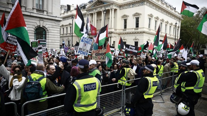 Police officers form a barrier between counter-protesters supporting Israel and pro-Palestinian supporters hold a demonstration in central London, on April 27, 2024, calling for a ceasefire and protesting against the export of arms from Britain to Israel. (Photo by BENJAMIN CREMEL / AFP)