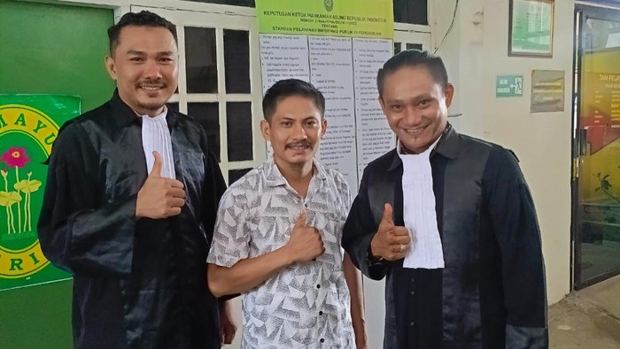 Kades Sandapang Yuil (tengah) bersama kuasa hukumnya usai menjalani sidang putusan di PN Mamuju.