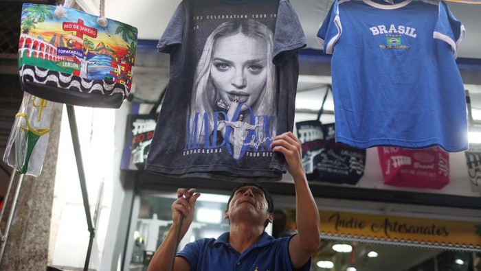 A seller displays a t-shirt with Madonna’s face for sale at a store, ahead of her concert at the Copacabana beach, in Rio de Janeiro, Brazil, April 30, 2024. REUTERS/Pilar Olivares