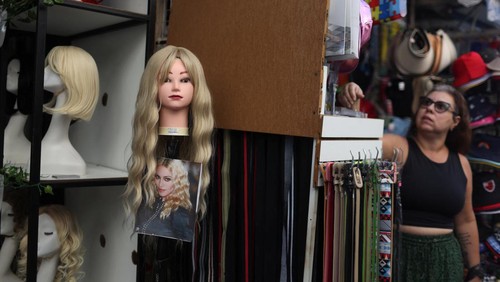 A wig is displayed, with a photo of Madonna, for sale at a store, ahead of her concert at the Copacabana beach, in Rio de Janeiro, Brazil, April 30, 2024. REUTERS/Pilar Olivares