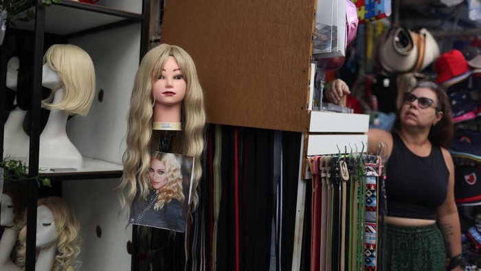 A wig is displayed, with a photo of Madonna, for sale at a store, ahead of her concert at the Copacabana beach, in Rio de Janeiro, Brazil, April 30, 2024. REUTERS/Pilar Olivares