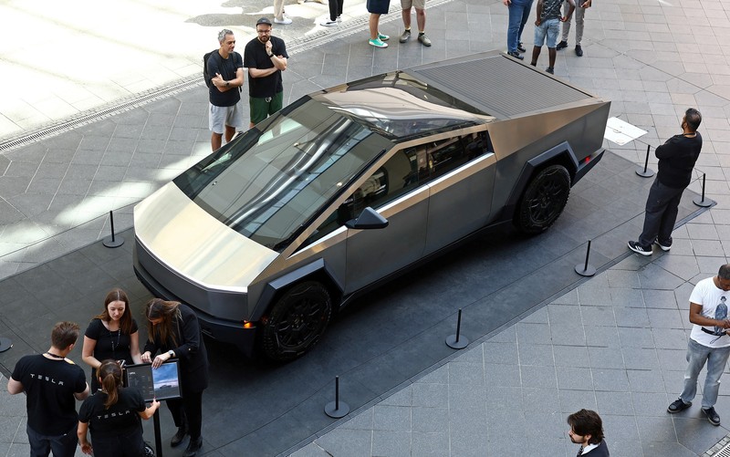 People gather around the Cybertruck vehicle by Tesla at the Mall of Berlin in Berlin, Germany, May 2, 2024. REUTERS/Lisi Niesner