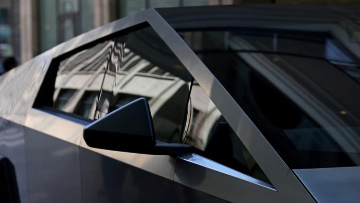 People gather around the Cybertruck vehicle by Tesla at the Mall of Berlin in Berlin, Germany, May 2, 2024. REUTERS/Lisi Niesner