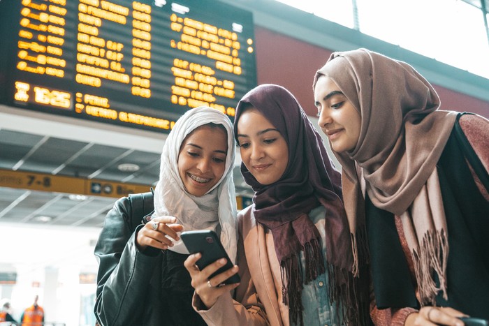 Young muslim women at train station leaving for a journey