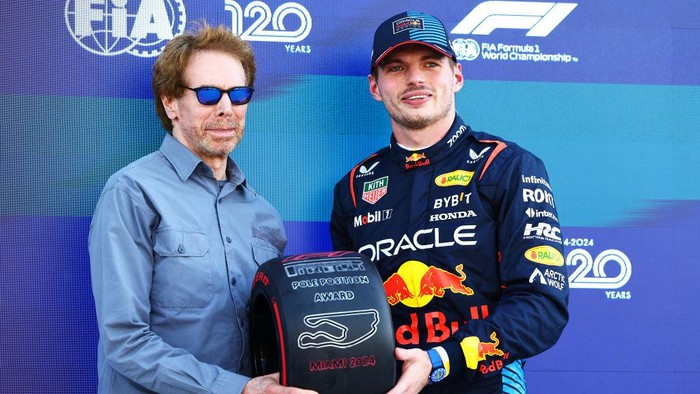 MIAMI, FLORIDA - MAY 04: Pole position qualifier Max Verstappen of the Netherlands and Oracle Red Bull Racing is presented with the Pirelli Pole Position Award by Jerry Bruckheimer, producer of the upcoming Formula One based movie, Apex, in parc ferme during qualifying ahead of the F1 Grand Prix of Miami at Miami International Autodrome on May 04, 2024 in Miami, Florida. (Photo by Mark Thompson/Getty Images)
