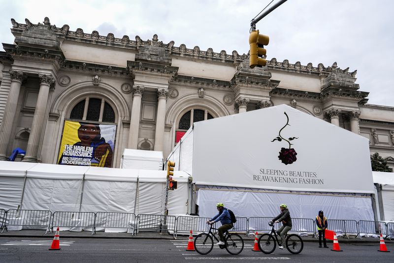 People pass by the Met Gala tent at the Metropolitan Museum of Art, Saturday, May 4, 2024, in New York. (AP Photo/Julia Nikhinson)