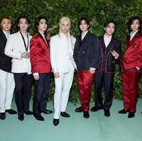 Leader grup KPop Stray Kids, Bangchan memakai three-piece wool suit berwarna navy dengan outline merah dan bros bunga sebagai aksesori. Sedangkan Felix tampil memakai silk suit putih dengan sulaman bunga yang selaras dengan dress code MET Gala 2024, The Garden of Time. Foto: Getty Images