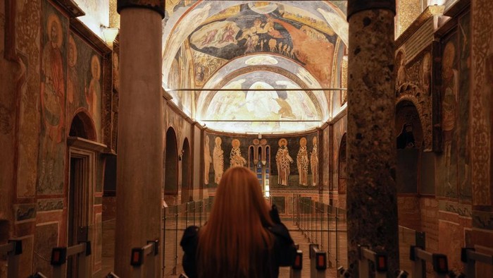 A Muslim cleric walks along a former Byzantine church which formally opened as a mosque, in Istanbul, Turkey, Monday, May 6, 2024. Turkish President Recep Tayyip Erdogan formally opened a former Byzantine church in Istanbul as a mosque on Monday, four years after his government had designated it a Muslim house of prayer, despite criticism from neighboring Greece. (AP Photo/Emrah Gurel)