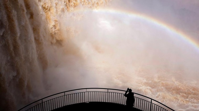 People tour Iguazu Falls, which are currently at full water capacity due to the rains in southern Brazil, at Iguazu Falls, Brazil, May 7, 2024. REUTERS/Kiko Sierich