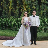 Mempelai pria, Rizky Febian, tampil elegan dalam balutan tailcoat tuxedo putih yang dipadankan celana hitam, dari koleksi Henri Winata. Foto: Instagram/@axioo @thebridestory @hiantjen @dhirmanputra