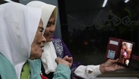 Beberapa calon jemaah haji terlihat menyapa sanak keluarga melalui video call sebelum lepas landas.